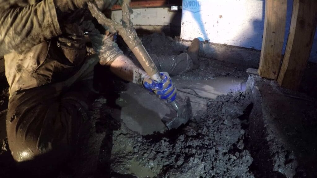man digging in a crawlspace