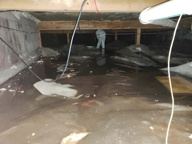 Wet crawl space Oregon home with visible moisture and standing water